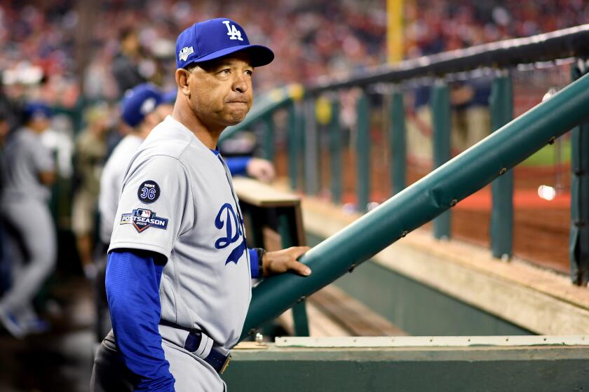 WASHINGTON D.C., OCTOBER 4, 2019-Dodgers manager Dave Robrts stands in the dugout before Game 3 of the NLDS at Nationals Stadium Sunday. (Wally Skalij/Los Angeles Times)