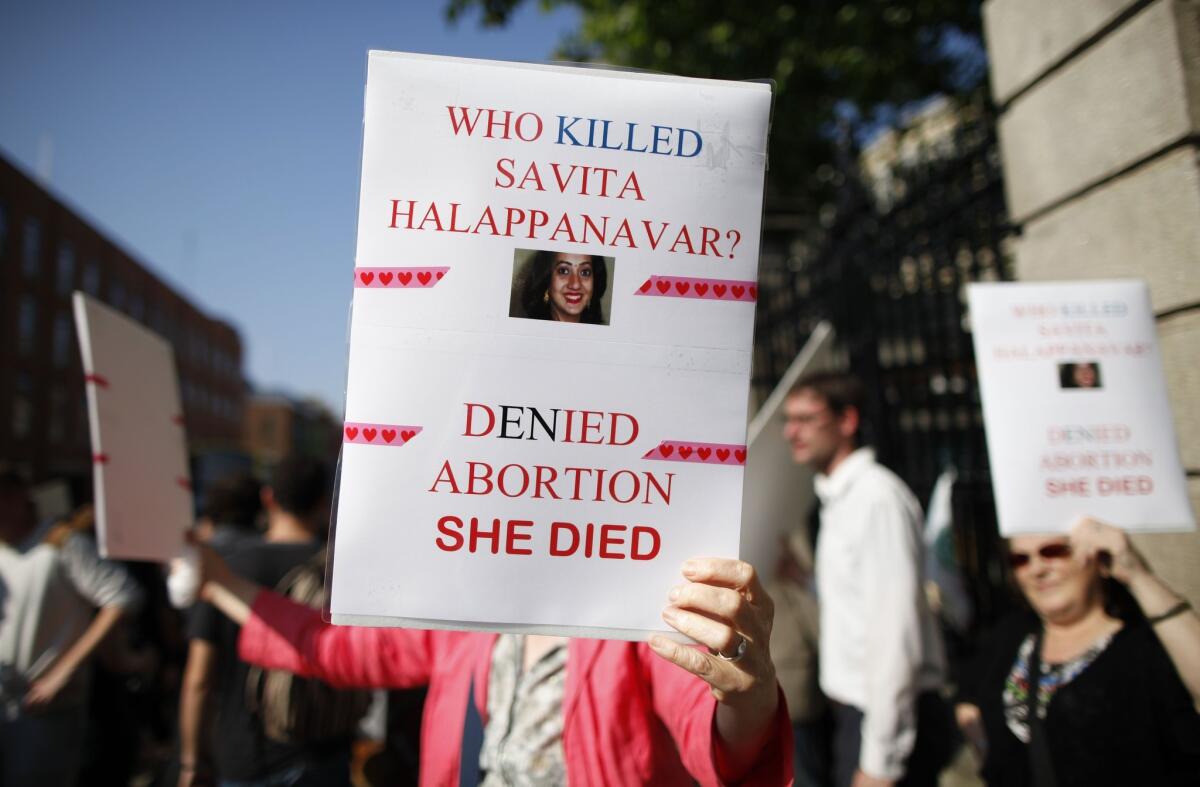 An abortion rights supporter holds up a placard outside the Irish Parliament building in Dublin earlier this month during a demonstration ahead of a vote to allow abortion in limited cases in Ireland.