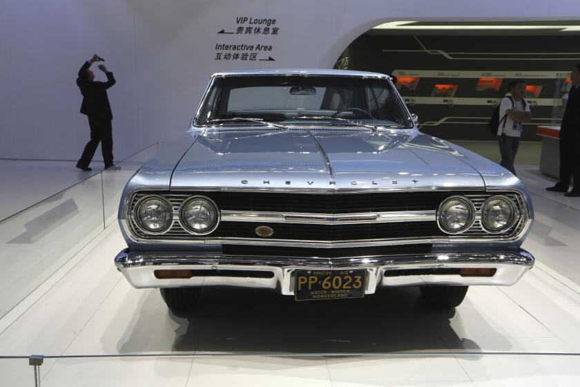 FILE - A 1965 Chevrolet Malibu is displayed at the company's booth during Guangzhou 2013 Auto Show in China's southern city of Guangzhou, Nov. 21, 2013. The Malibu, the last midsize car made by a Detroit automaker, is heading for the junkyard. General Motors confirmed Thursday, May 9, 2024, that it will stop making the car introduced in 1964 as the company focuses more on electric vehicles. (AP Photo/Kin Cheung, File)