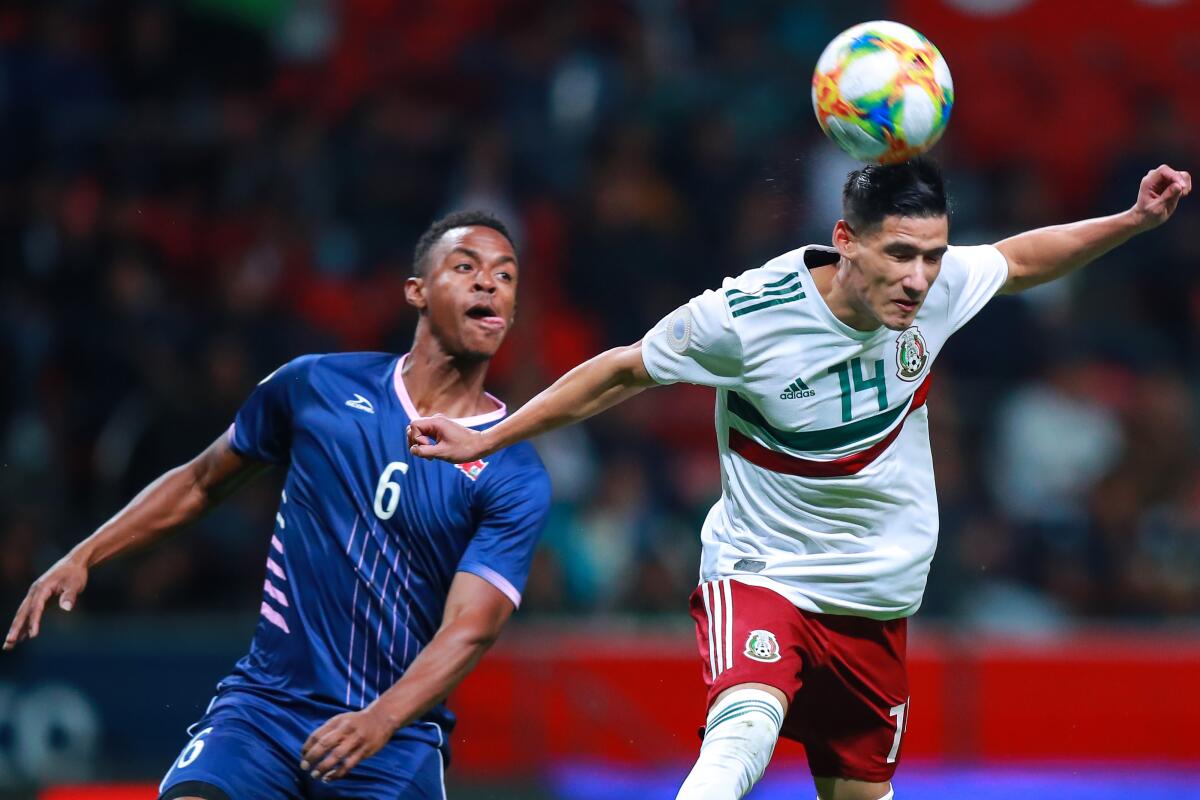 TOLUCA, MEXICO - NOVEMBER 19: Uriel Antuna #14 of Mexico vies for the ball against Jaylon Bather #6 of Bermuda during the match between Mexico and Bermuda as part of the Concacaf Nation League at Nemesio Diez Stadium on November 19, 2019 in Toluca, Mexico. (Photo by Manuel Velasquez/Getty Images) ** OUTS - ELSENT, FPG, CM - OUTS * NM, PH, VA if sourced by CT, LA or MoD **