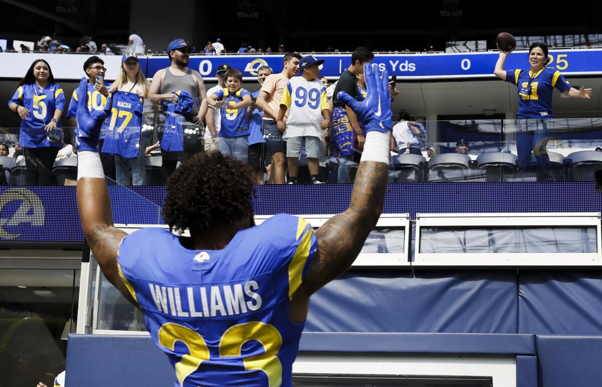Rams running back Kyren Williams (23) cheers with the crowd after leading a win over the Cardinals.