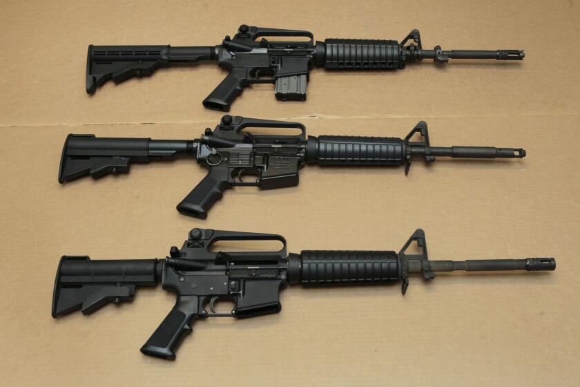 Three variations of the AR-15 assault rifle are displayed at the California Department of Justice in Sacramento.