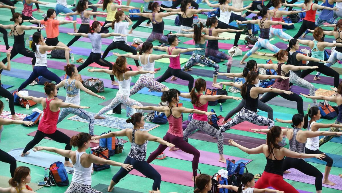 Participants at the South Korea Yoga Marathon perform yoga moves at the Jangchung Gymnasium in Seoul. Singapore is offering a $749 round-trip fare to Seoul.