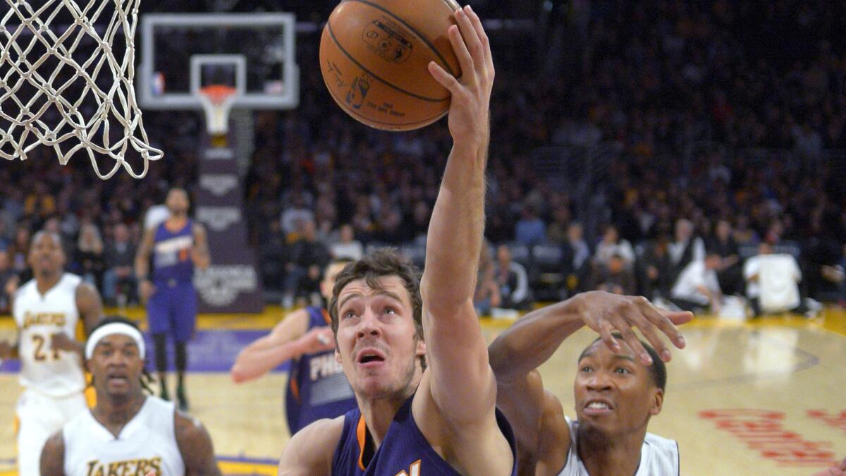 Phoenix Suns guard Goran Dragic puts up a shot over Lakers forward Wesley Johnson during a game at Staples Center on Dec. 28, 2014.