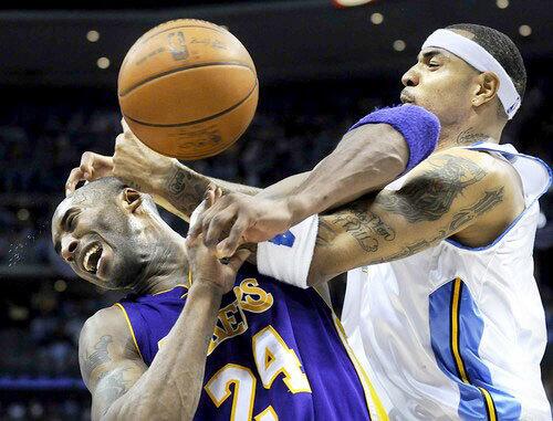 Lakers guard Kobe Bryant is fouled by Nuggets power forward Kenyon Martin late in the fourth quarter Saturday night. Bryant would finish with 41 points in the victory.