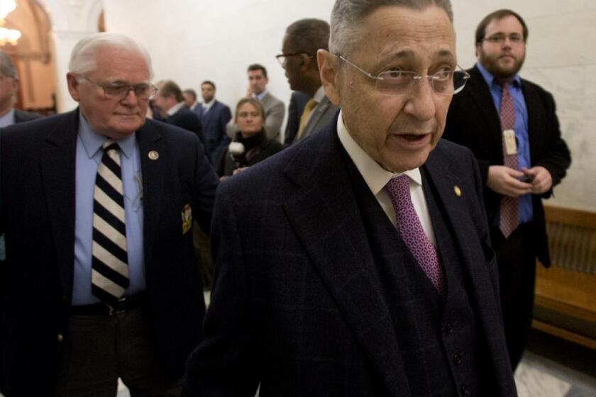 Former Assembly Speaker Sheldon Silver walks through the New York state Capitol shortly before stepping down amid accusations of fraud.