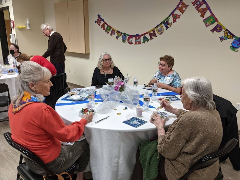 Guests have lunch during the Senior Hanukkah Party at the Lawrence Family Jewish Community Center in La Jolla.