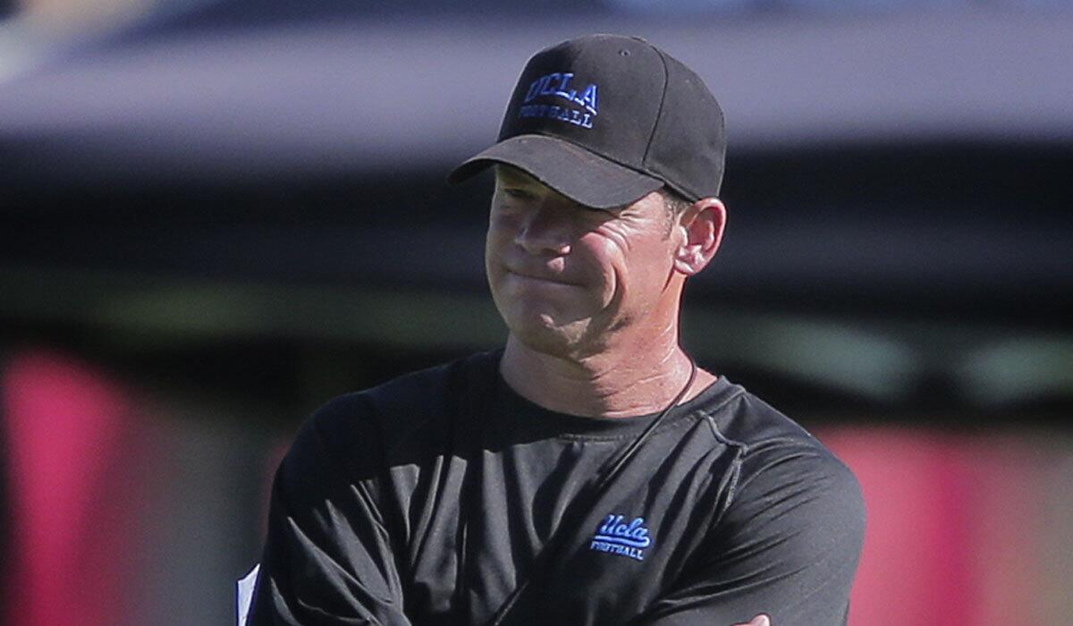 UCLA Coach Jim Mora looks on during the first day of training camp on Aug. 10.