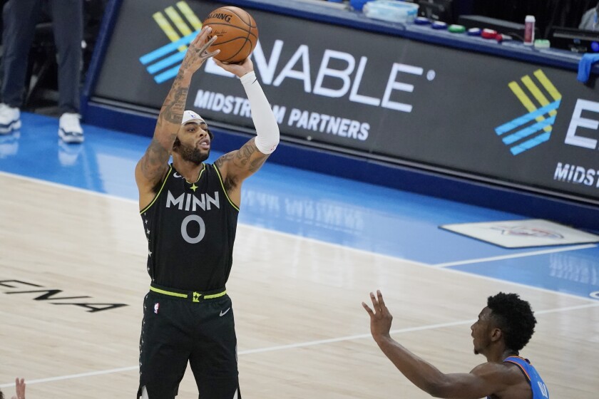 Minnesota Timberwolves guard D'Angelo Russell (0) shoots a three-point basket over Oklahoma City Thunder guard Hamidou Diallo, right, in the final seconds of an NBA basketball game Friday, Feb. 5, 2021, in Oklahoma City. (AP Photo/Sue Ogrocki)