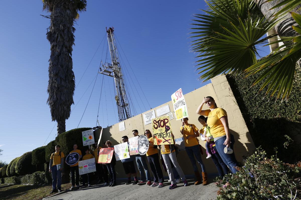 Community activists protest the use of acid and other chemicals at the Jefferson Boulevard drilling site in South Los Angeles in November.