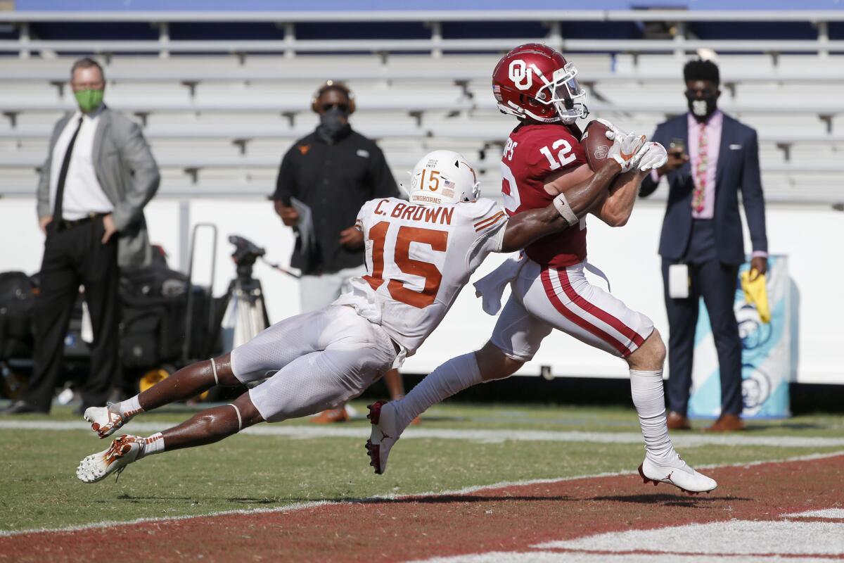 Oklahoma wide receiver Drake Stoops breaks away from Texas defensive back Chris Brown to score the winning touchdown.