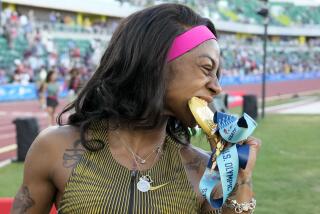 Sha'Carri Richardson celebrates her win in the wins women's 100-meter run final.