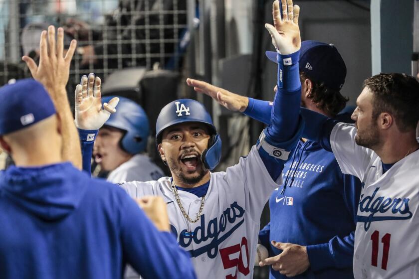 Los Angeles, CA, Tuesday, August 31, 2021 - Los Angeles Dodgers right fielder Mookie Betts (50) celebrates in the dugout after hitting a 4th inning homer off Atlanta Braves starting pitcher Charlie Morton (50) at Dodger Stadium. (Robert Gauthier/Los Angeles Times)