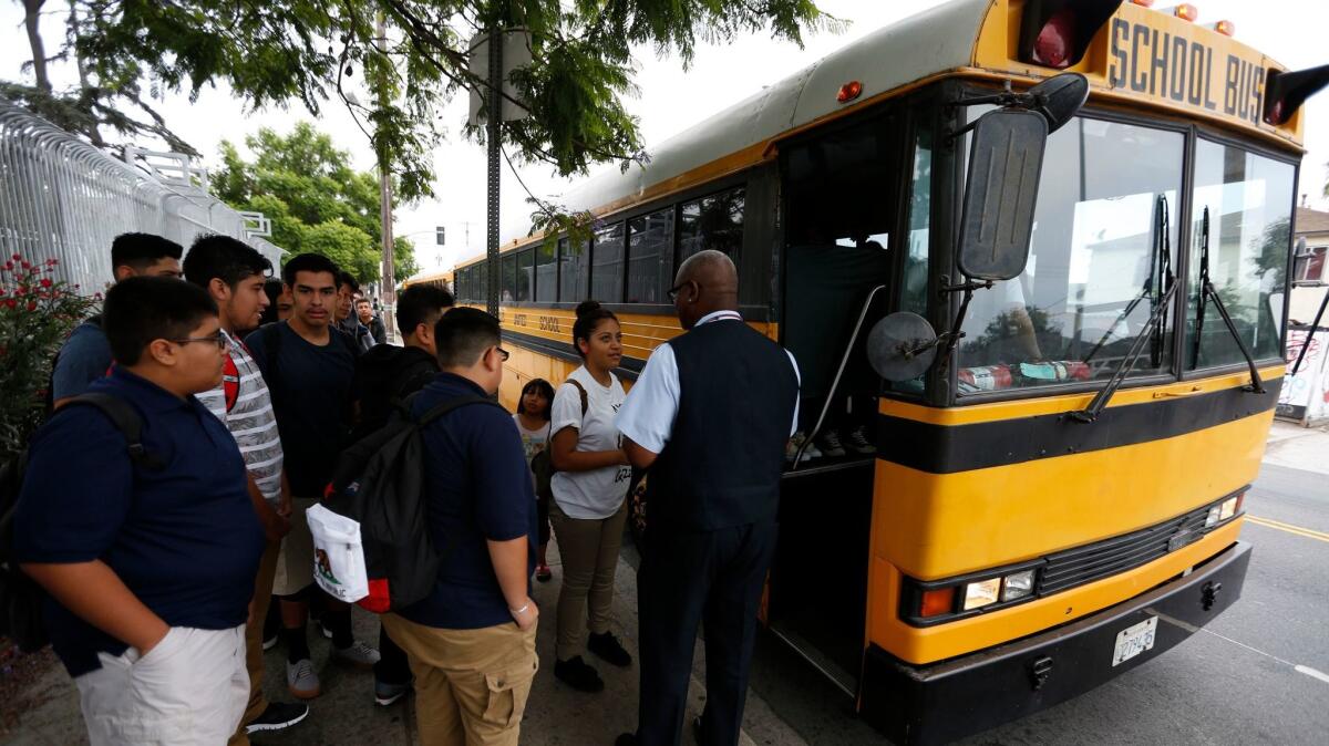 LOS ANGELES ,CA AUGUST 18, 2015: Students line-up for their buses at a district bus stop next to Jefferson High School in Los Angeles on the first day of classes August 18, 2015. The buses transport the students to middle schools and other high schools in the area (Mark Boster / Los Angeles Times ).