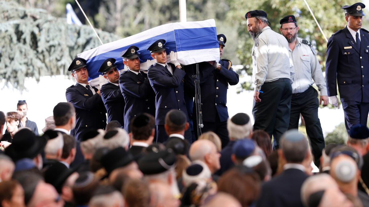 Knesset guards carry the flag-draped coffin during the funeral for former Israeli President Shimon Peres at the Mount Herzl national cemetery in Jerusalem on Friday.