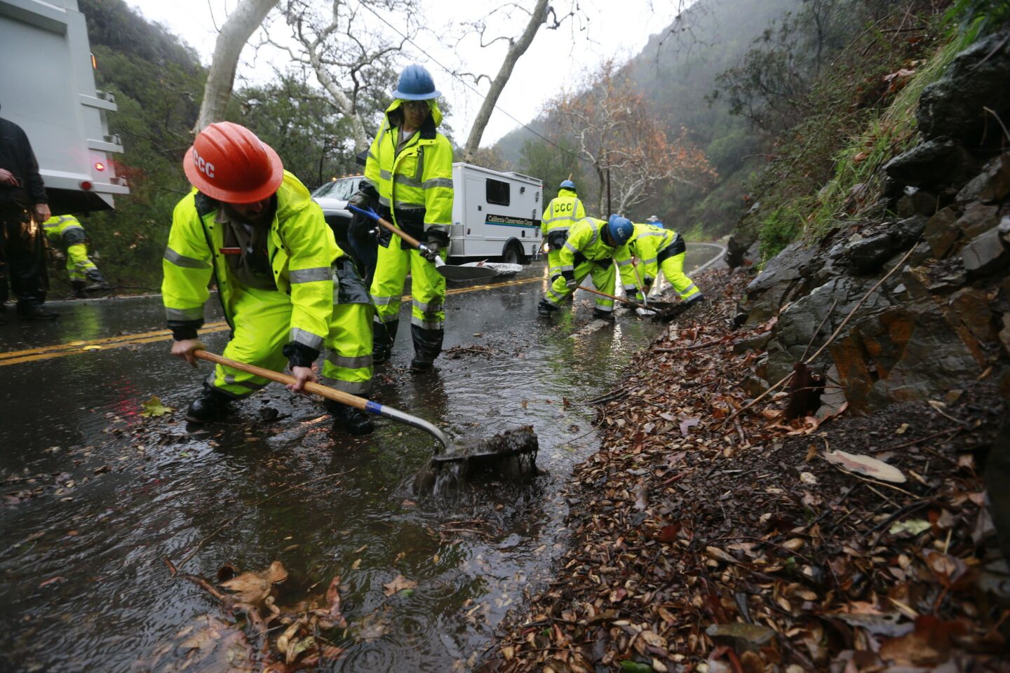 Members of the California Conservation Corps clear drains along Silverado Canyon Road in Orange County, Calif.