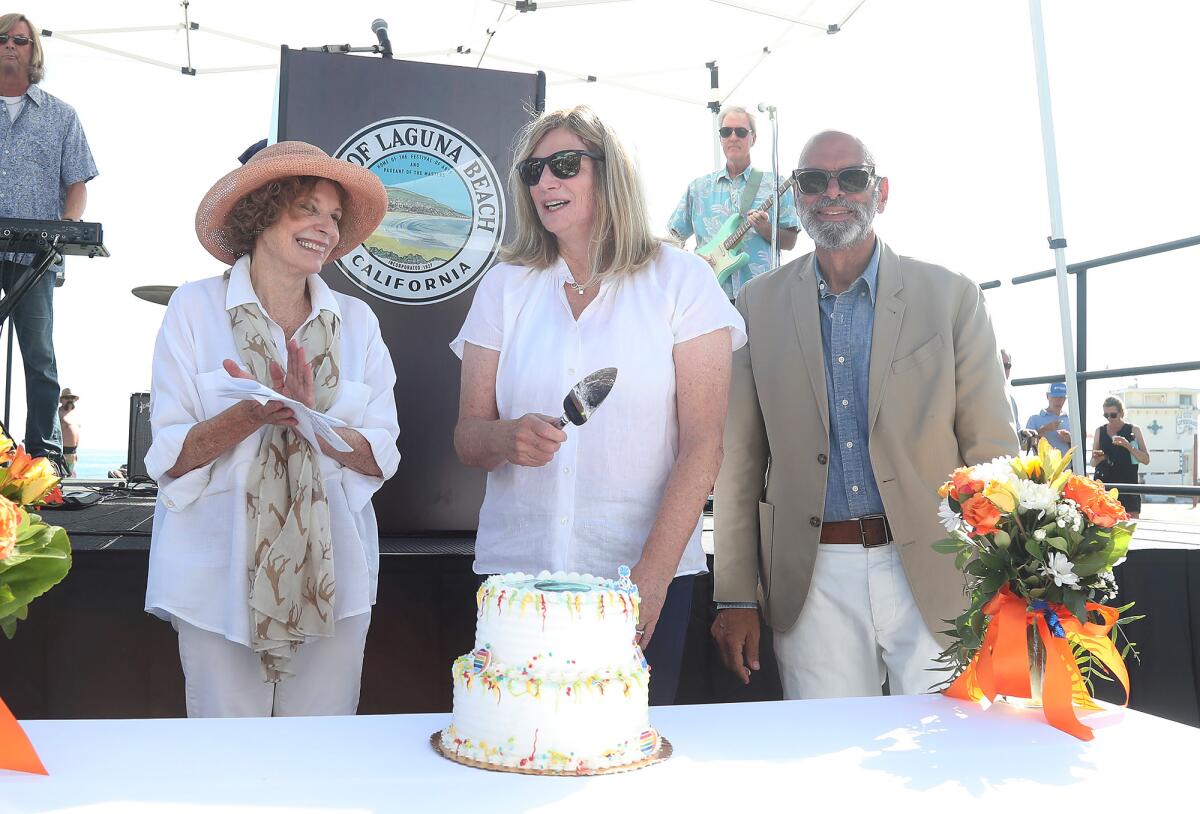 Councilwoman Toni Iseman, Mayor Sue Kempf and Councilman Peter Blake cut the official cake.