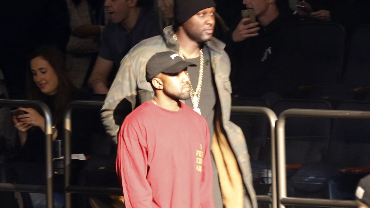 Lamar Odom, background, and Kanye West enter Madison Square Garden for the unveiling of the Yeezy collection and album release for West's latest album, "The Life of Pablo," on , Feb. 11, 2016 during Fashion Week in New York.