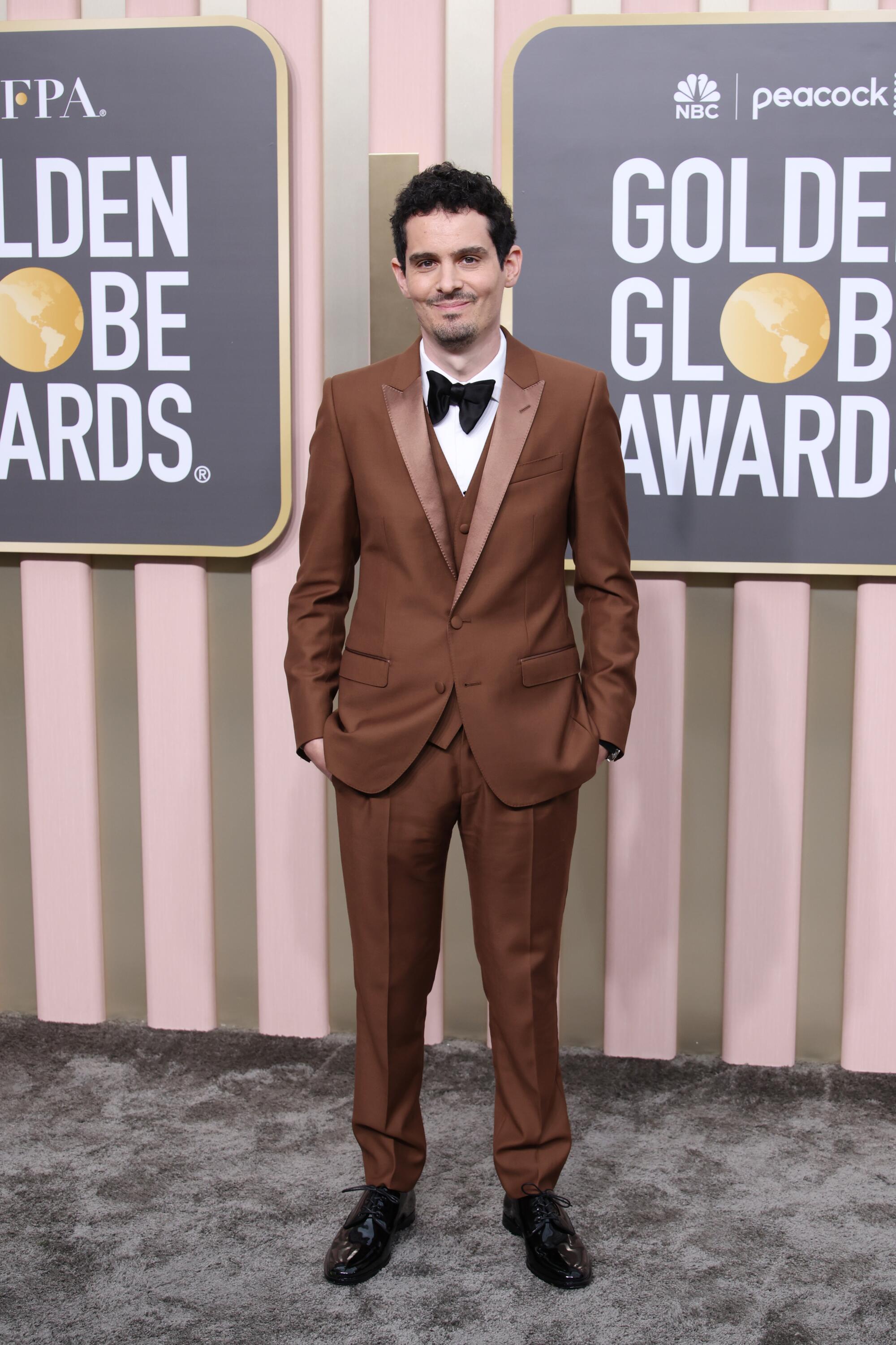 Damien Chazelle poses in a brown tux