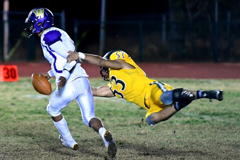 PARADISE, CALIFORNIA OCTOBER 18, 2019-Paradise's Sam Gieg sacks Willows quarterback Odell Calzada Friday night in Paradise, California. (Wally Skalij/Los Angeles Times)