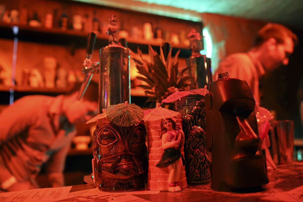 Tiki themed mugs stand on the bar inside of the secret tiki bar PDTiki during weekend one of the three-day Coachella Valley Music and Arts Festival at the Empire Polo Grounds on Saturday, April 15, 2017 in Indio, Calif. Goldenvoice food and beverage director Nic Adler teamed with the bartenders at PDT (Please Don't Tell) in Manhattan, New York, to open a 35-person bar in the general admission area. An assortment of restaurants and chefs are providing unique food and crafted drink options for the festival. (Patrick T. Fallon/ For The Los Angeles Times)
