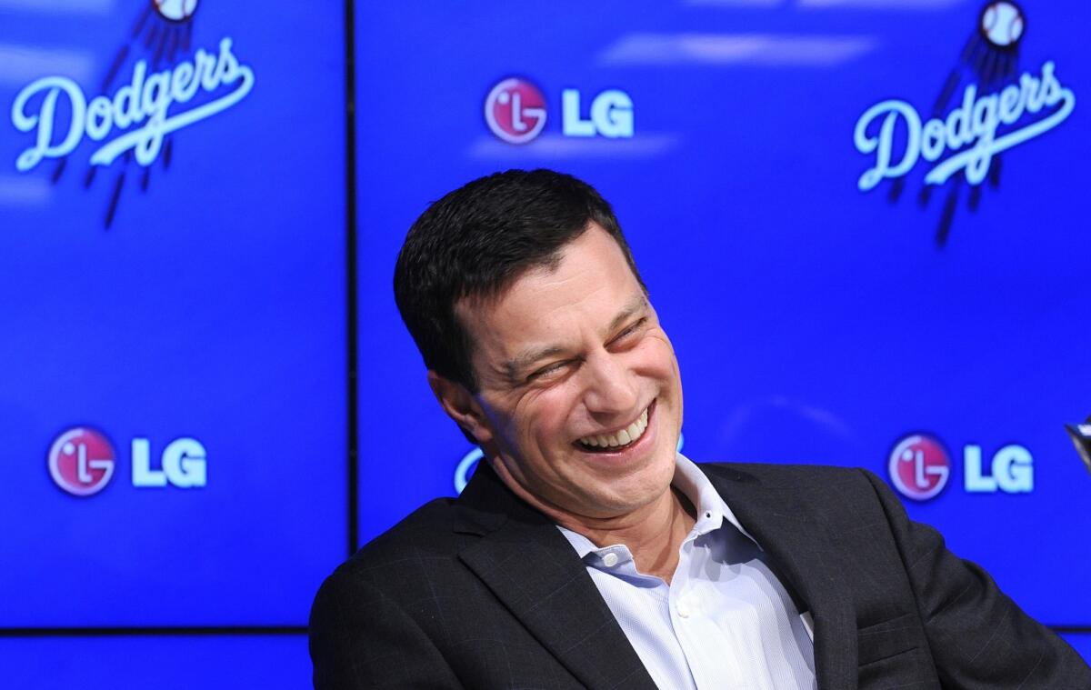 Andrew Friedman, the Dodgers' new president of baseball operations, breaks into laughter during his introductory news conference on Friday.