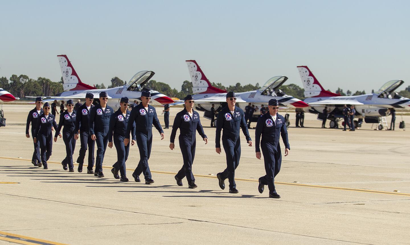 Members of the Air Force Thunderbirds aerial demonstration squadron walk to meet members of the media Thursday at the Los Alamitos Joint Forces Training Base as they get ready for this weekend's Great Pacific Airshow in Huntington Beach.