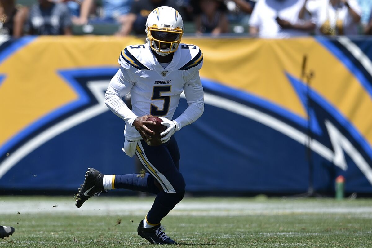 Chargers quarterback Tyrod Taylor runs with the ball.