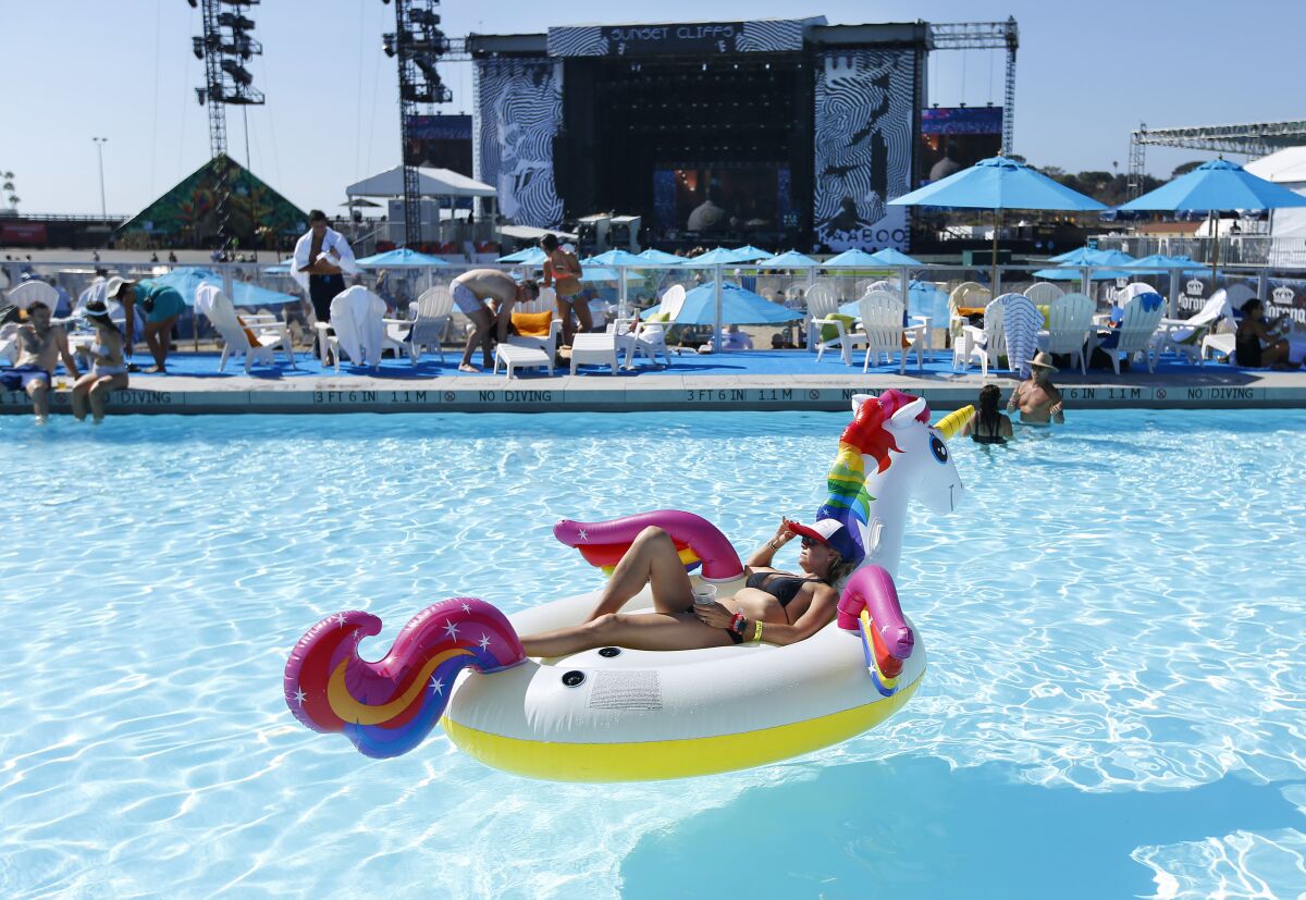 Shannon Thomas floats in the Bask Swim Club as Andrew McMahon performs on the Sunset Cliff Stage at KAABOO Del Mar on Sept. 13, 2019.