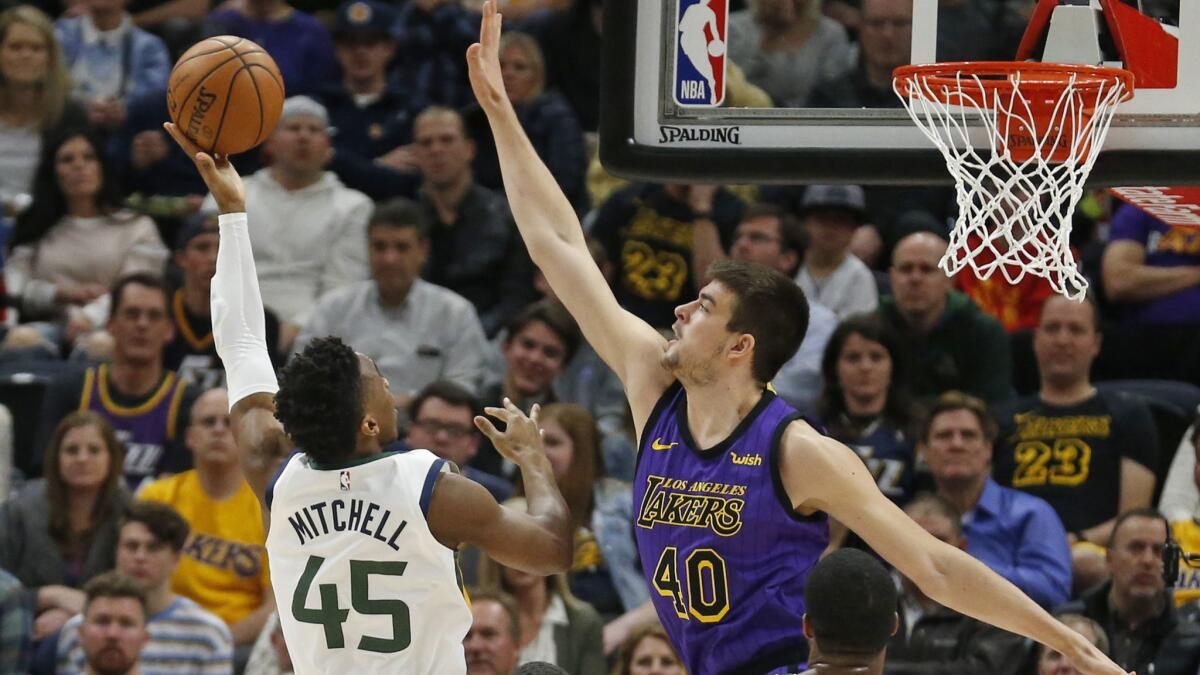 Jazz guard Donovan Mitchell has his shot challenged by Lakers center Ivica Zubac during the first half Friday.