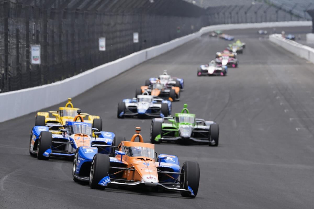 Scott Dixon, of New Zealand, leads a pack of cars into a turn during a practice session for the Indianapolis 500 auto race at Indianapolis Motor Speedway, Monday, May 20, 2024, in Indianapolis. (AP Photo/Darron Cummings)