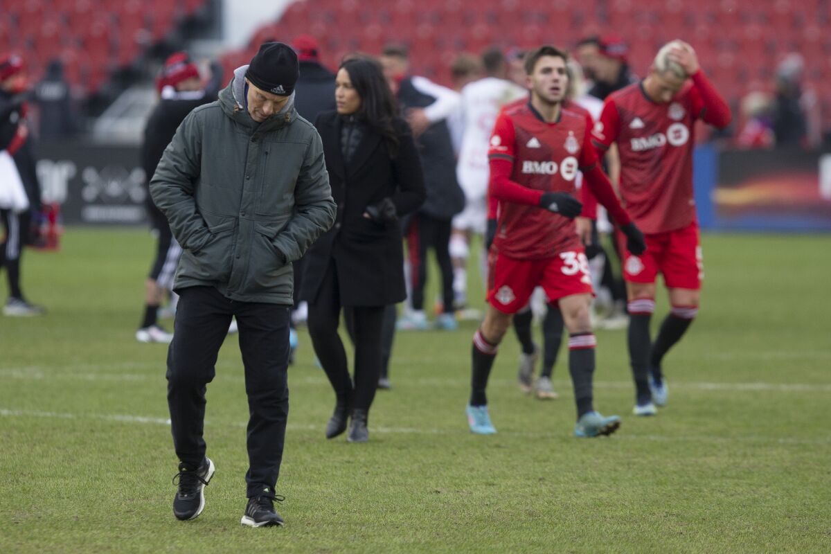 New Toronto FC head coach Bob Bradley walks across the pitch after seeing his team lose 4-1 to the New York Red Bulls in their home opener in an MLS soccer match, in Toronto, Saturday, March 5, 2022. (Chris Young/The Canadian Press via AP)