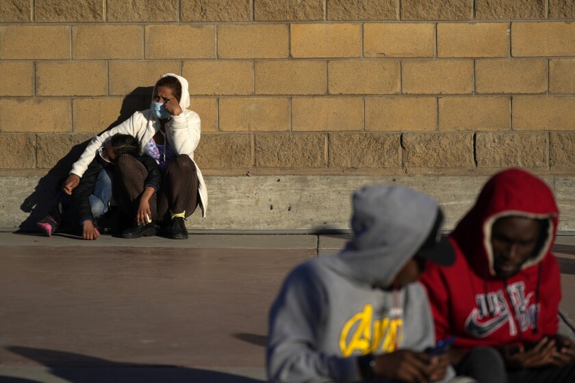 FILE - Asylum seekers wait for news of policy changes at the border on Feb. 19, 2021, in Tijuana, Mexico. The Biden administration is set to reinstate a Trump-era policy to make asylum-seekers wait in Mexico for hearings in U.S. immigration court this week with changes and additions. A U.S. official says the first migrants are to be sent from El Paso, Texas, back to Ciudad Juarez. Timing was in flux as officials made final preparations but it may begin Tuesday, Dec. 7, 2021. (AP Photo/Gregory Bull)