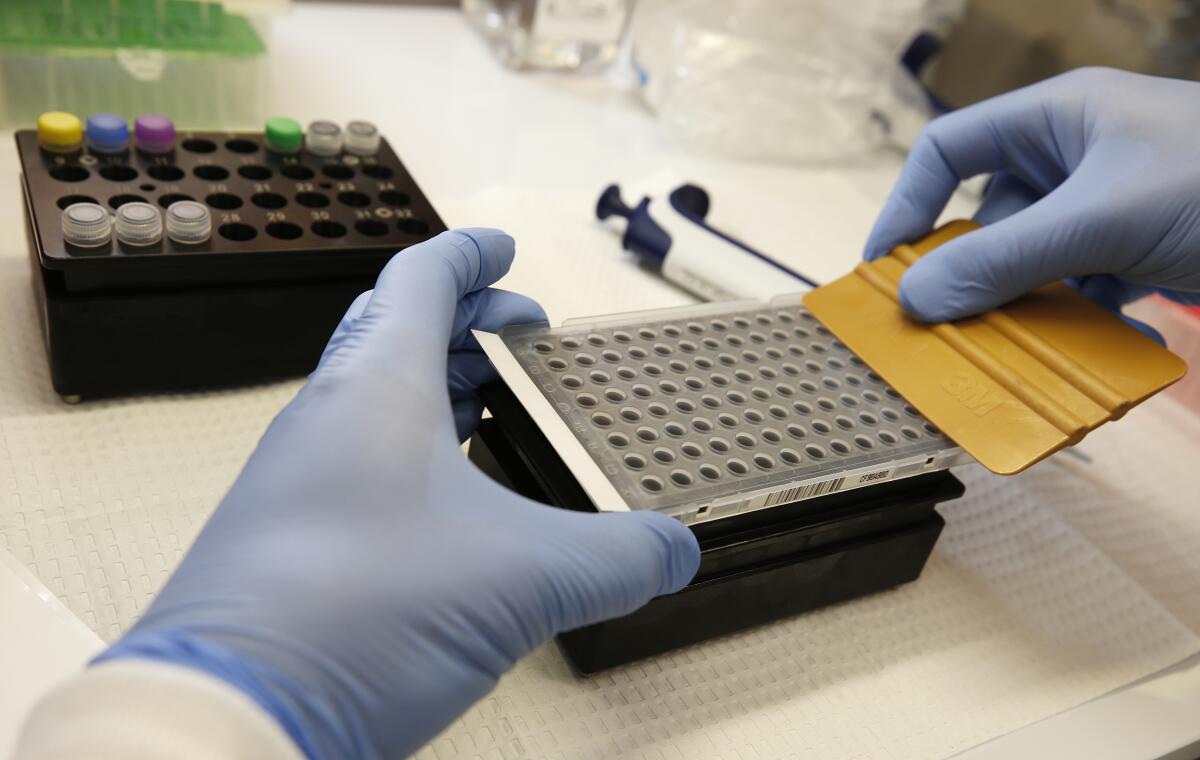 Brian Bowland, a senior clinical lab specialist at UCLA Health System, prepares a kit used in coronavirus detection.