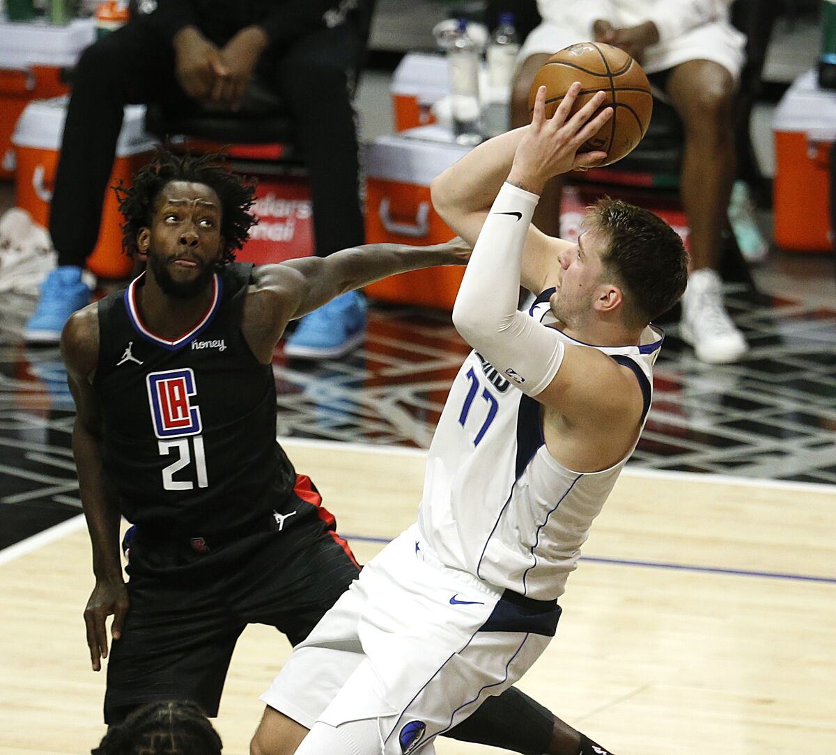 Dallas guard Luka Doncic takes a fallback shot while defended by Clippers' Patrick Beverley.