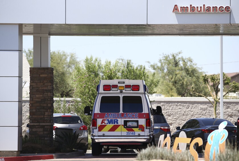 An ambulance is parked at Arizona General Hospital in Laveen, Ariz. 
