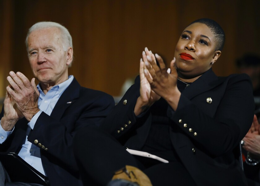 FILE - Then Democratic presidential candidate, former Vice President Joe Biden and senior adviser Symone Sanders participate in a campaign event in Iowa City, Iowa on Jan. 27, 2020. MSNBC says it has hired Sanders to host a weekend television show and another on its Peacock streaming service. It continues the trend of former political pros jumping to jobs on cable TV. (AP Photo/Matt Rourke, File)