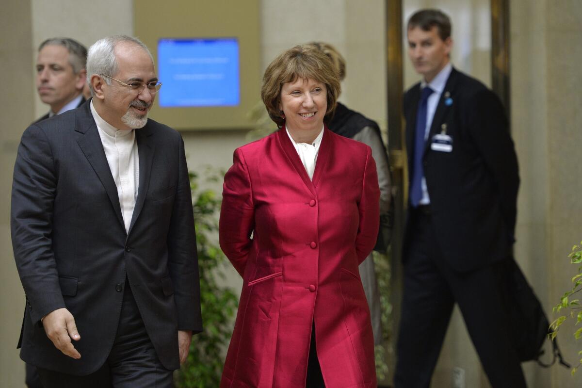 The European Union's foreign policy chief, Catherine Ashton, right, accompanies Iranian Foreign Minister Mohammad Javad Zarif, before the start of two days of closed-door nuclear talks at the United Nations offices in Geneva.