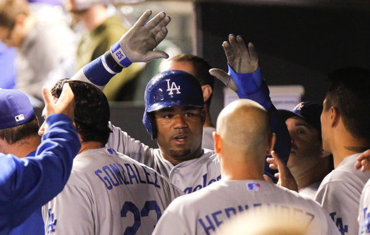 Dodgers' Carl Crawford is congratulated after scoring the winning run during the tenth inning.
