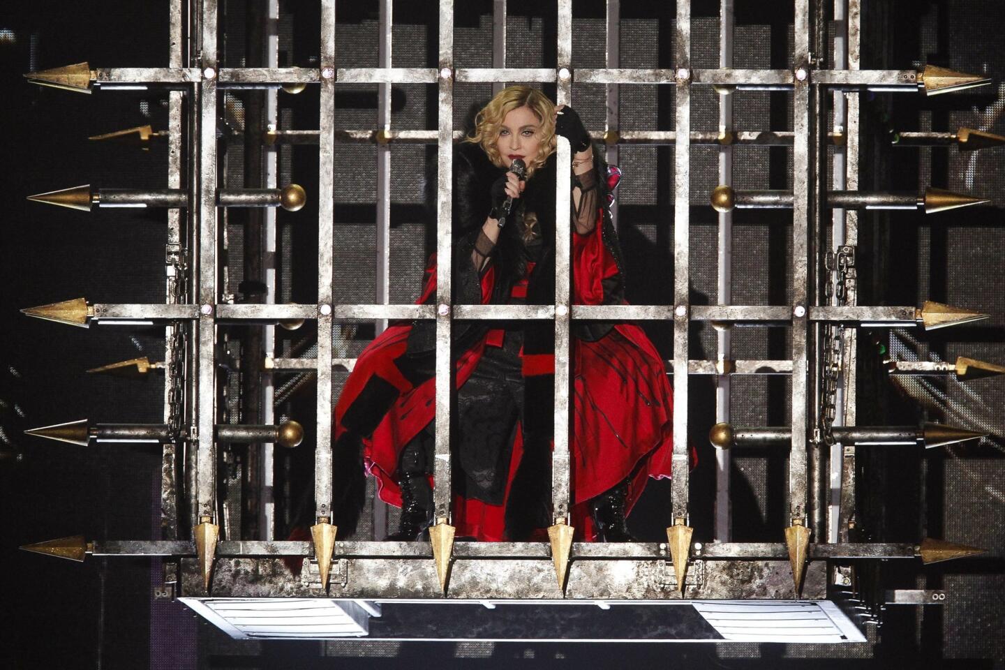 Madonna descends in a cage.
