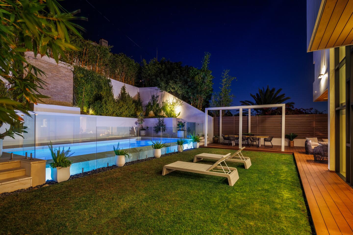 Lawn with furniture and foliage.