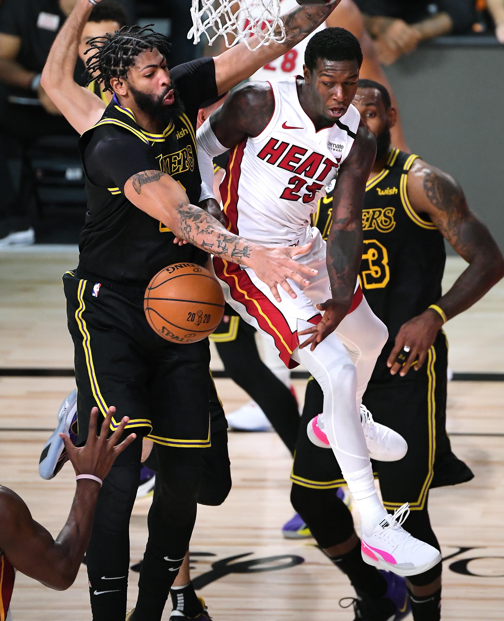 Miami's Kendrick Nunn passes in front of Lakers forward Anthony Davis.