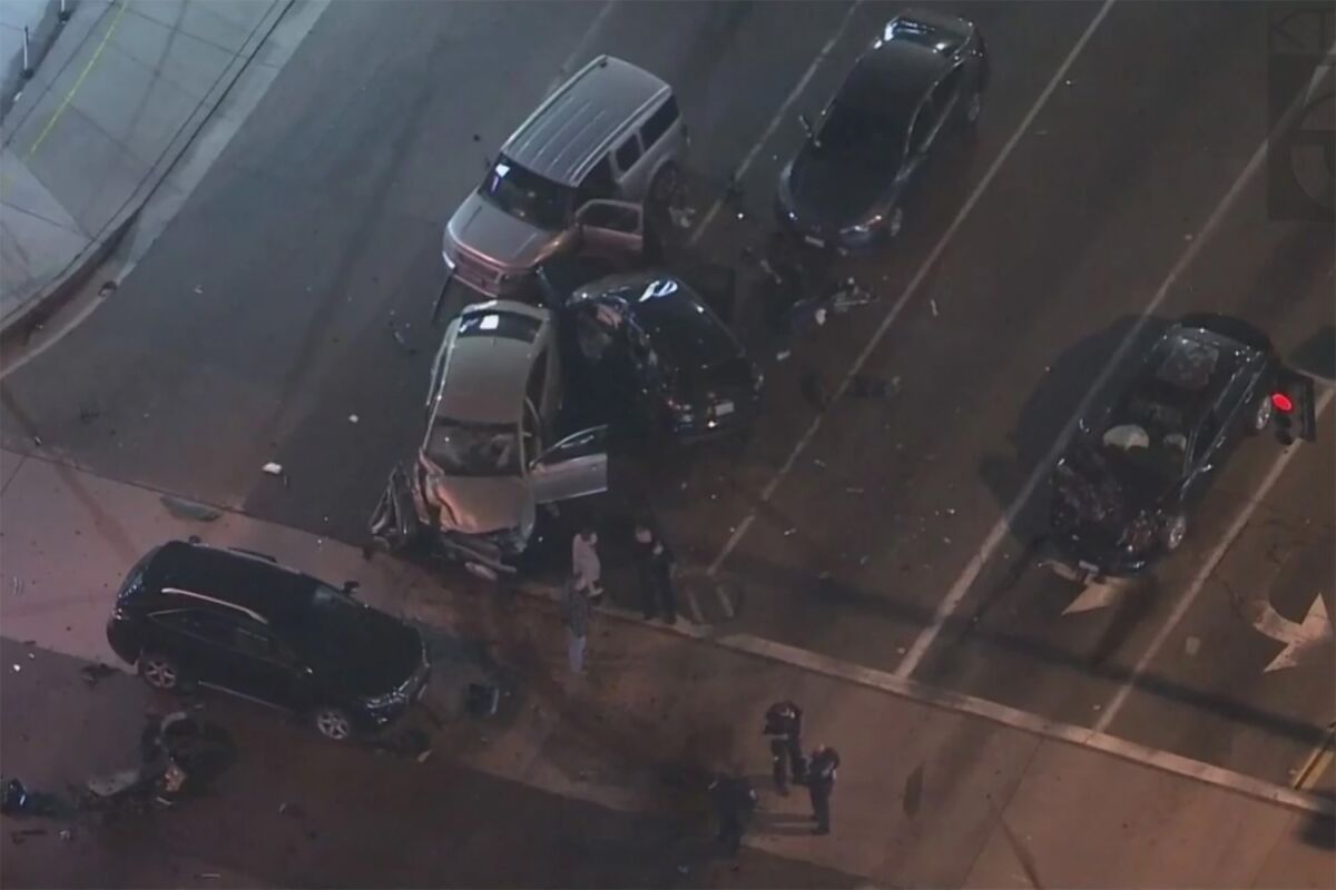 Aerial view of six severely damaged cars at an intersection.