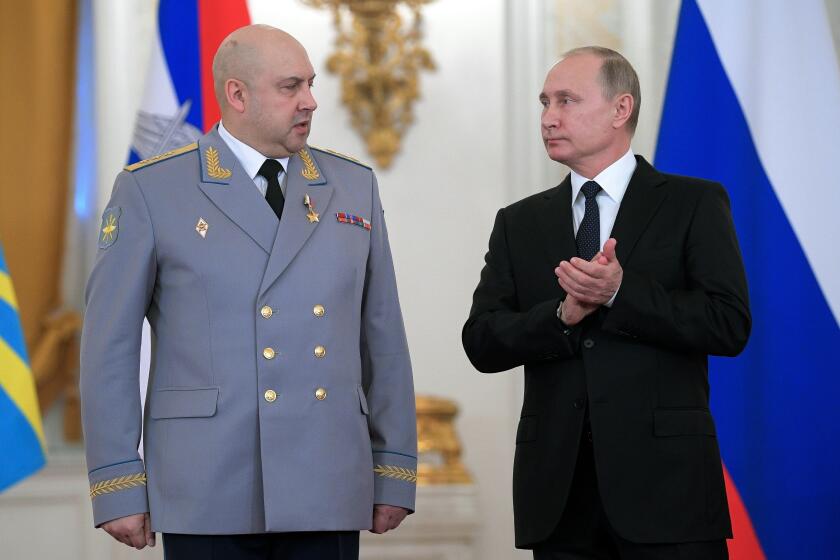 FILE - Russian President Vladimir Putin, right, applauds Col. Gen. Sergei Surovikin during an awards ceremony for troops who fought in Syria, in the Kremlin, in Moscow, Russia, Dec. 28, 2017. Russia’s president has succeeded in exiling Wagner mercenary head Yevgeny Prigozhin, who led a brief mutiny last week, but the fate of several top generals is still unclear. There were unconfirmed reports that one of them with ties to Prigozhin has been arrested and another was mysteriously absent from several events attended by President Vladimir Putin and embattled Defense Minister Sergei Shoigu. (Alexei Druzhinin, Sputnik, Kremlin Pool Photo via AP, File)