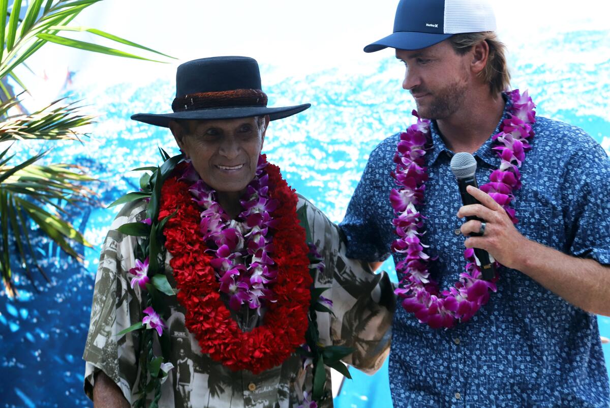 Local Huntington Beach surfer Brett Simpson inducts Ilima Kalama into the Surfers' Hall of Fame during Friday's ceremony.