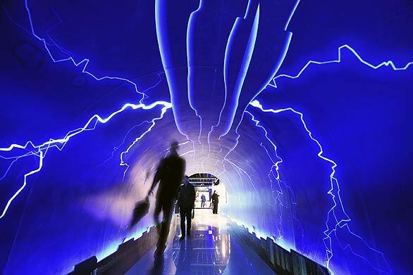 In this photo released by China's Xinhua news agency, visitors walk through the Thunderbolt Passage inside the Meteorologic Popular Science Hall for Public Experience, which opens Monday in Hangzhou, capital of China's Zhejiang province, to mark World Meteorological Day.