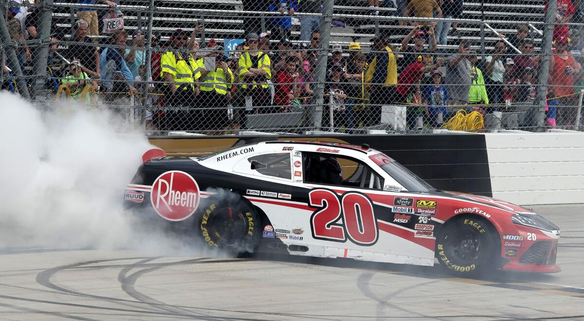 Christopher Bell does a burnout after winning the NASCAR Xfinity Series race on Saturday at Dover International Speedway.