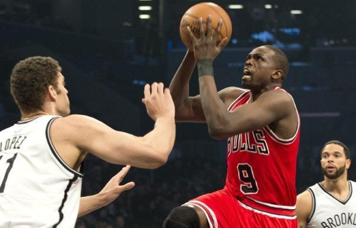 Bulls forward Luol Deng drives to the basket against Nets center Brooke Lopez in Game 5 on Monday in Brooklyn.