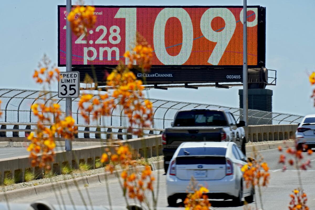 A digital billboard above a roadway displays 109 degrees
