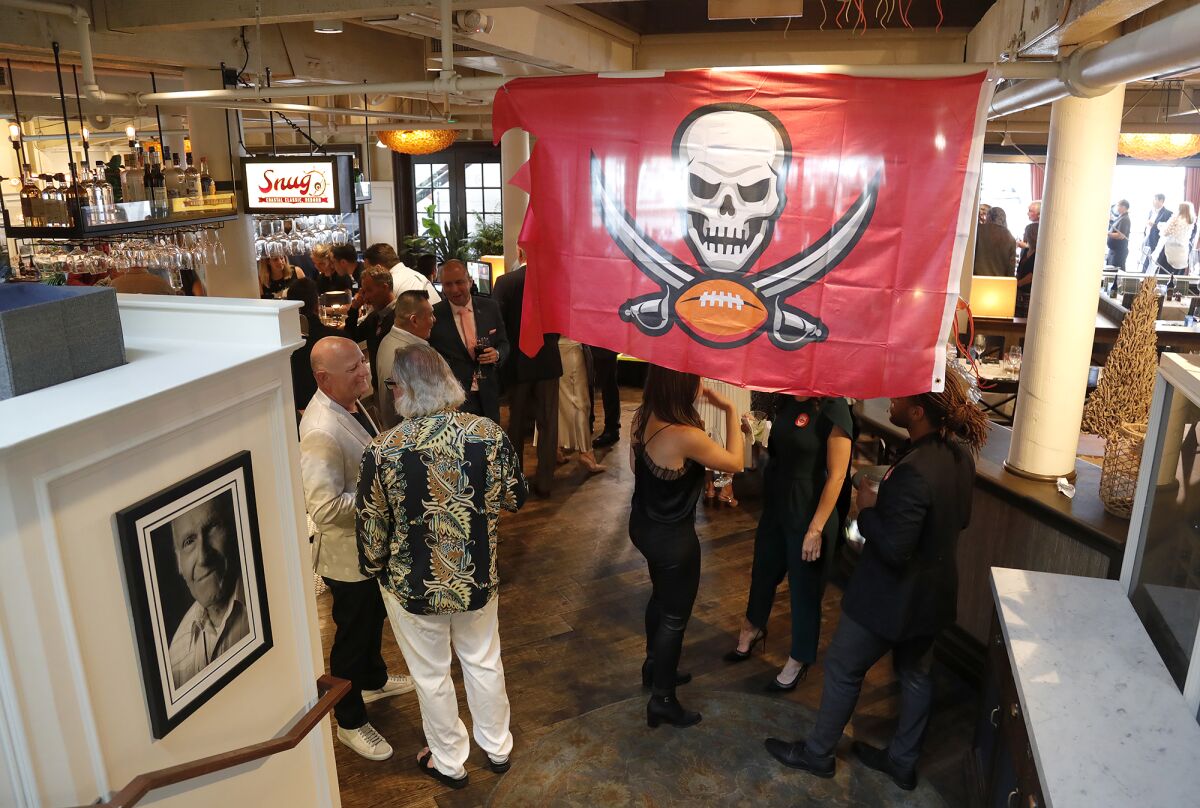 A Tampa Bay Buccaneers flag hangs at the annual Irrelevant Week All-Star Lowsman Banquet on Monday night.
